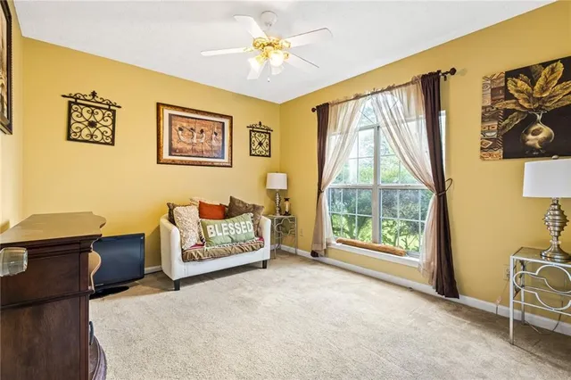 a living room with furniture and a floor to ceiling window