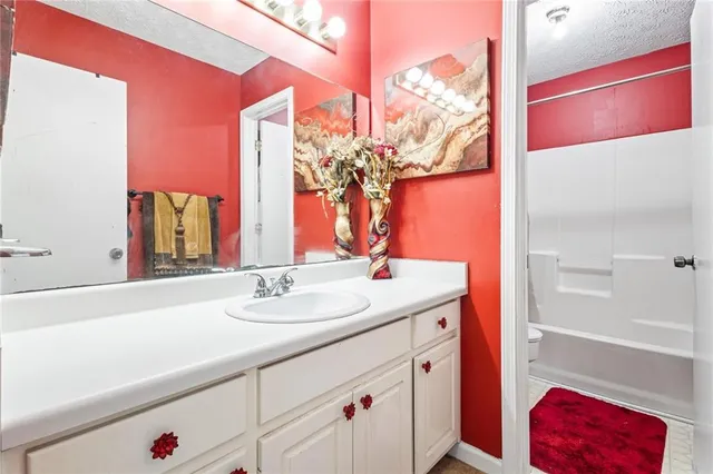 a bathroom with a sink vanity and a mirror