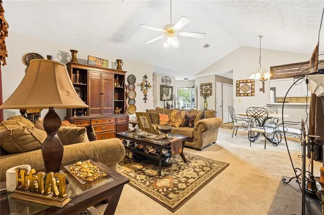 a living room with furniture a rug and a chandelier