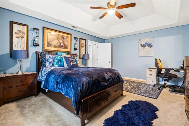 a spacious bedroom with a bed and window