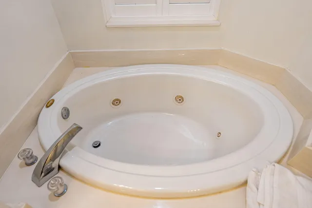 a bedroom with two beds and a large window