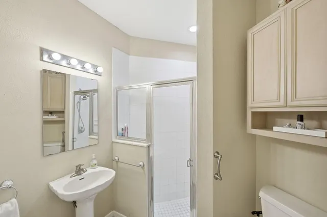 a bathroom that has a glass shower door