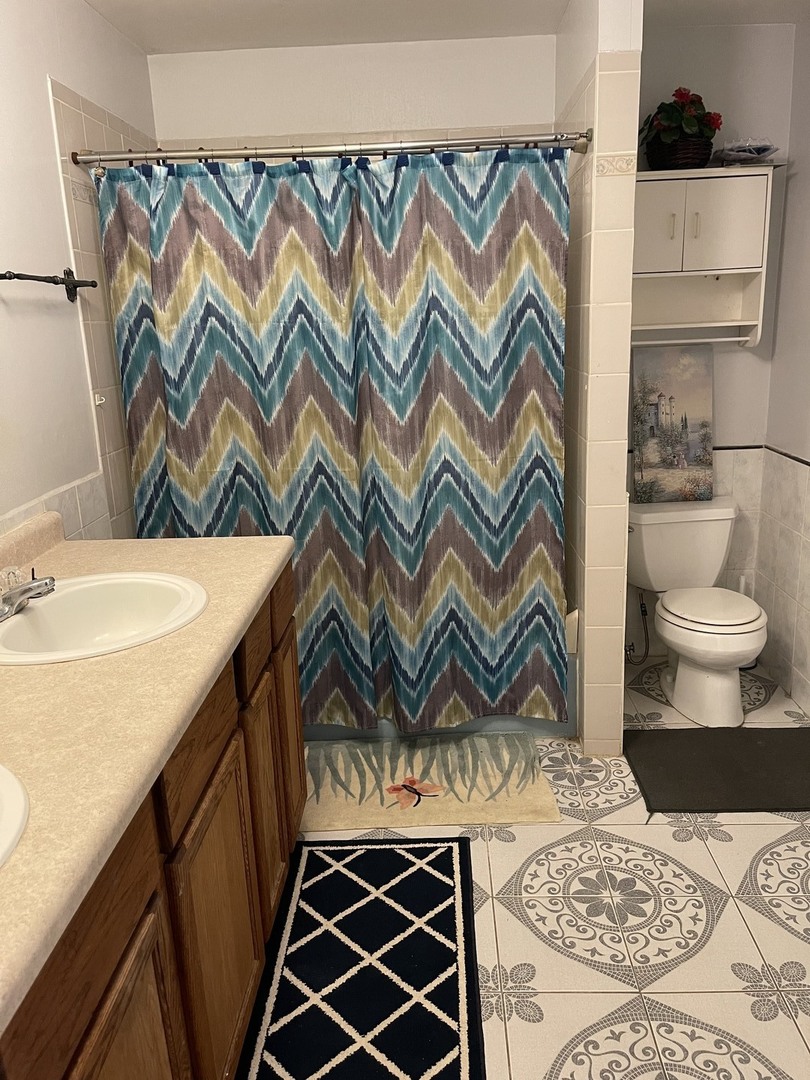 6602 Wander Way Cary, IL 60013 - Photo 25 of 45 a bathroom with a sink and a mirror
