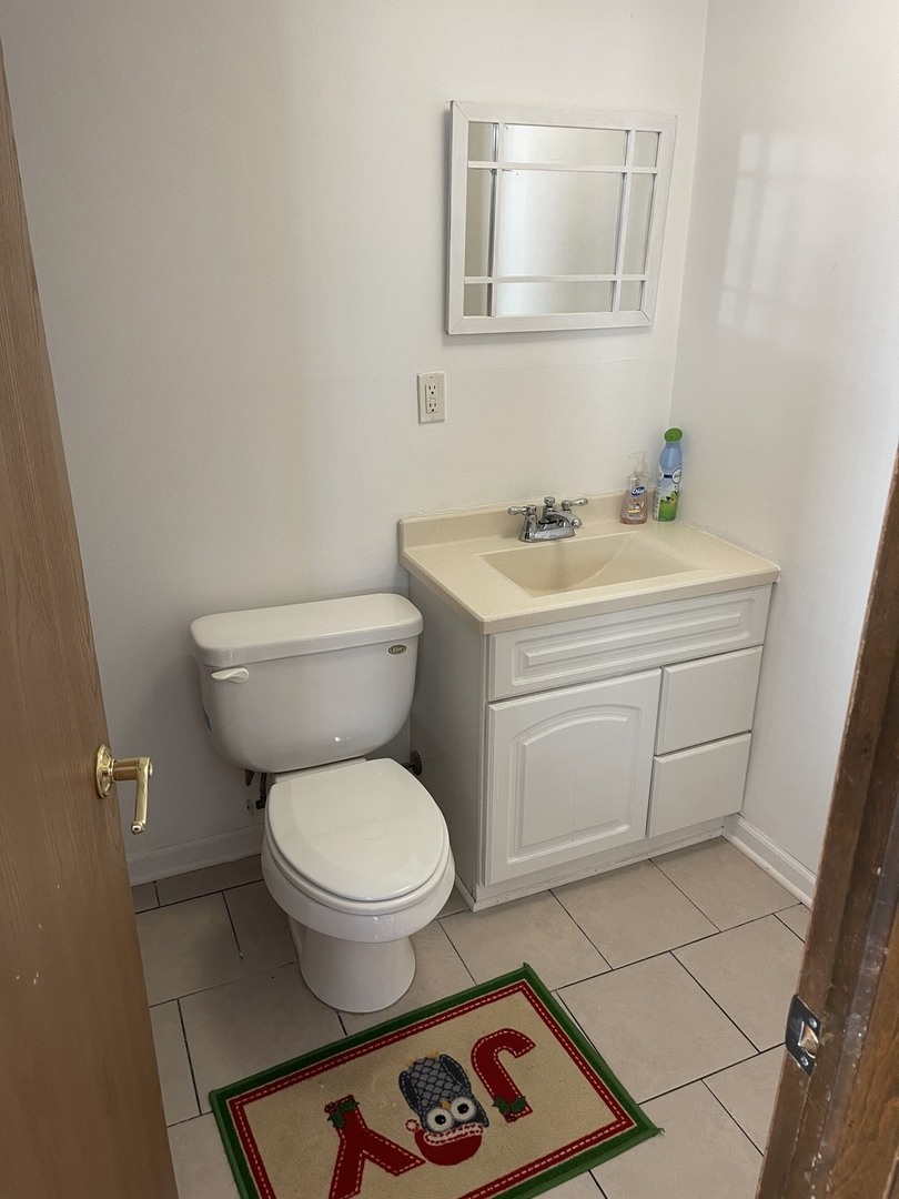 6602 Wander Way Cary, IL 60013 - Photo 33 of 45 a bathroom with a toilet sink and mirror