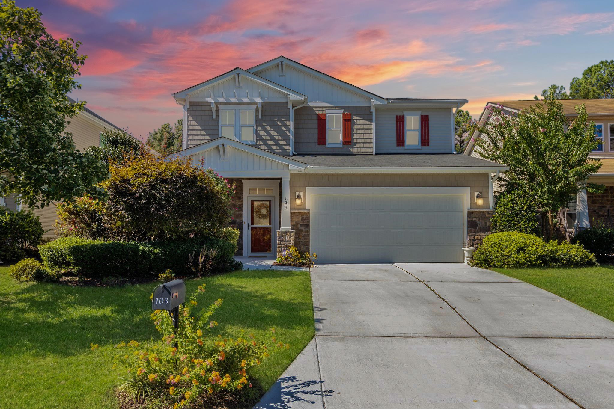 103 Daneborg Road Durham, NC 27703 - Photo 1 of 44 a front view of a house with a yard and potted plants