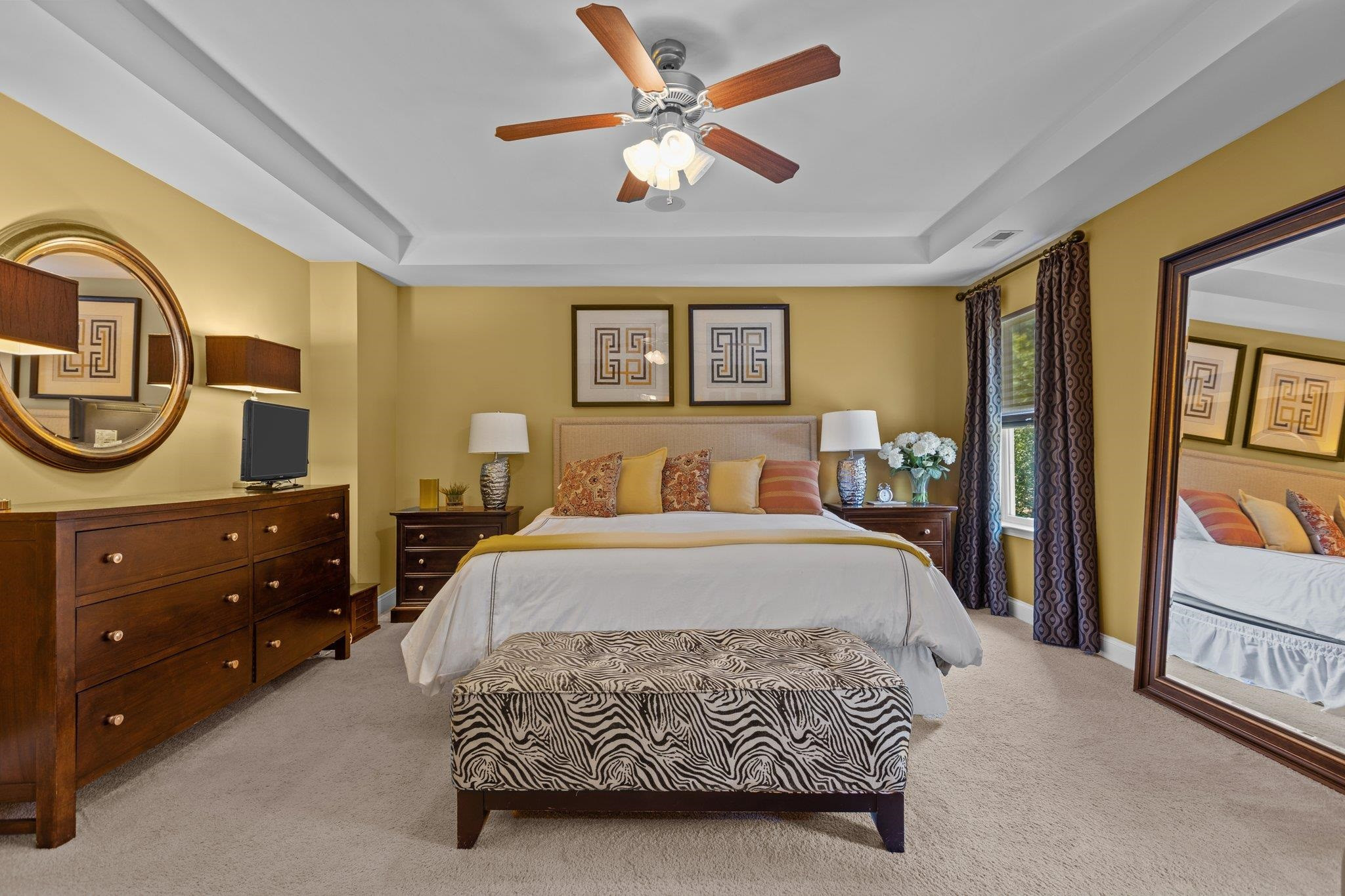 103 Daneborg Road Durham, NC 27703 - Photo 25 of 44 a bedroom with a bed a mirror on dresser and a chandelier