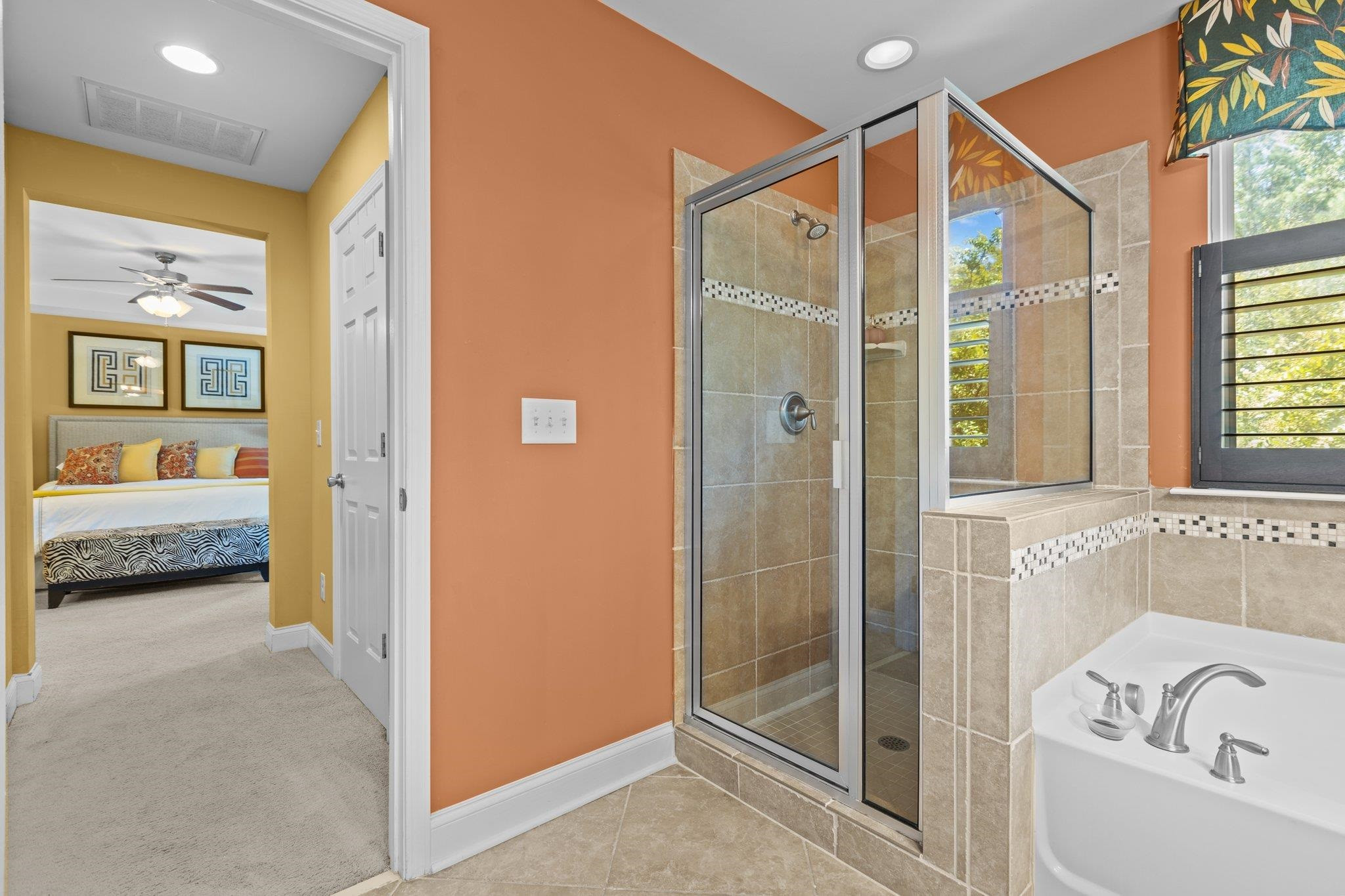 103 Daneborg Road Durham, NC 27703 - Photo 27 of 44 a en suite bathroom with a tub shower and windows