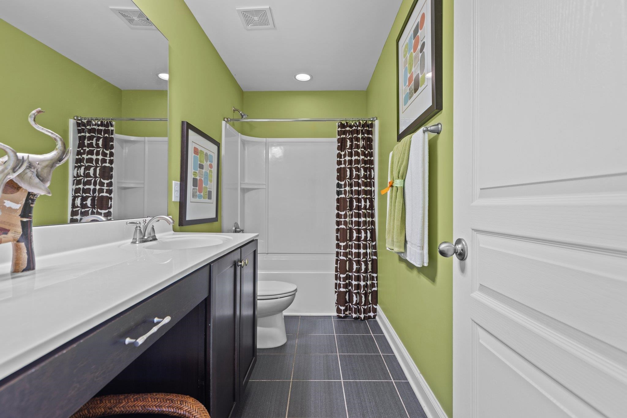 103 Daneborg Road Durham, NC 27703 - Photo 30 of 44 a bathroom with a double vanity sink toilet and shower