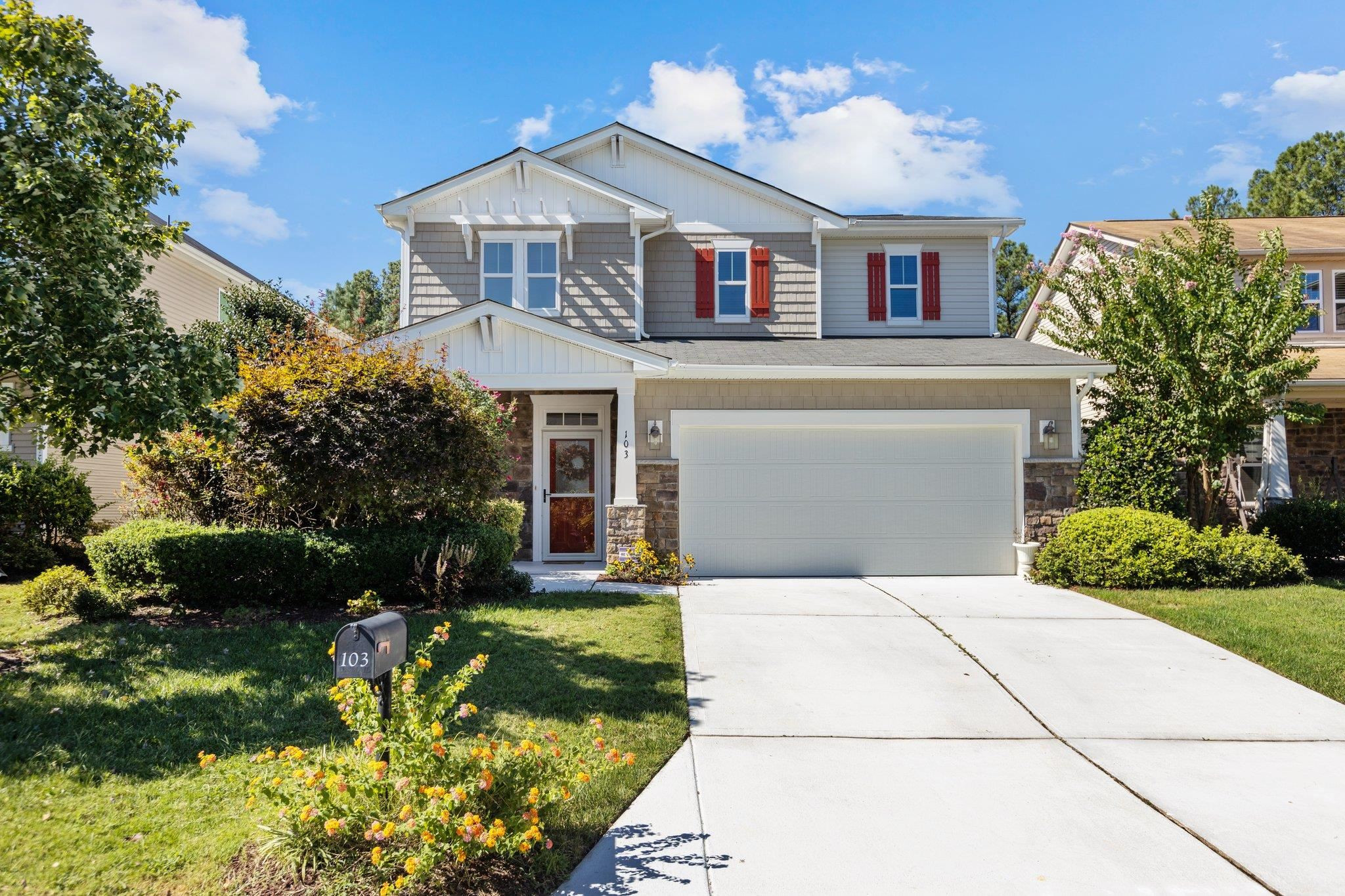 103 Daneborg Road Durham, NC 27703 - Photo 3 of 44 a front view of a house with a yard and potted plants