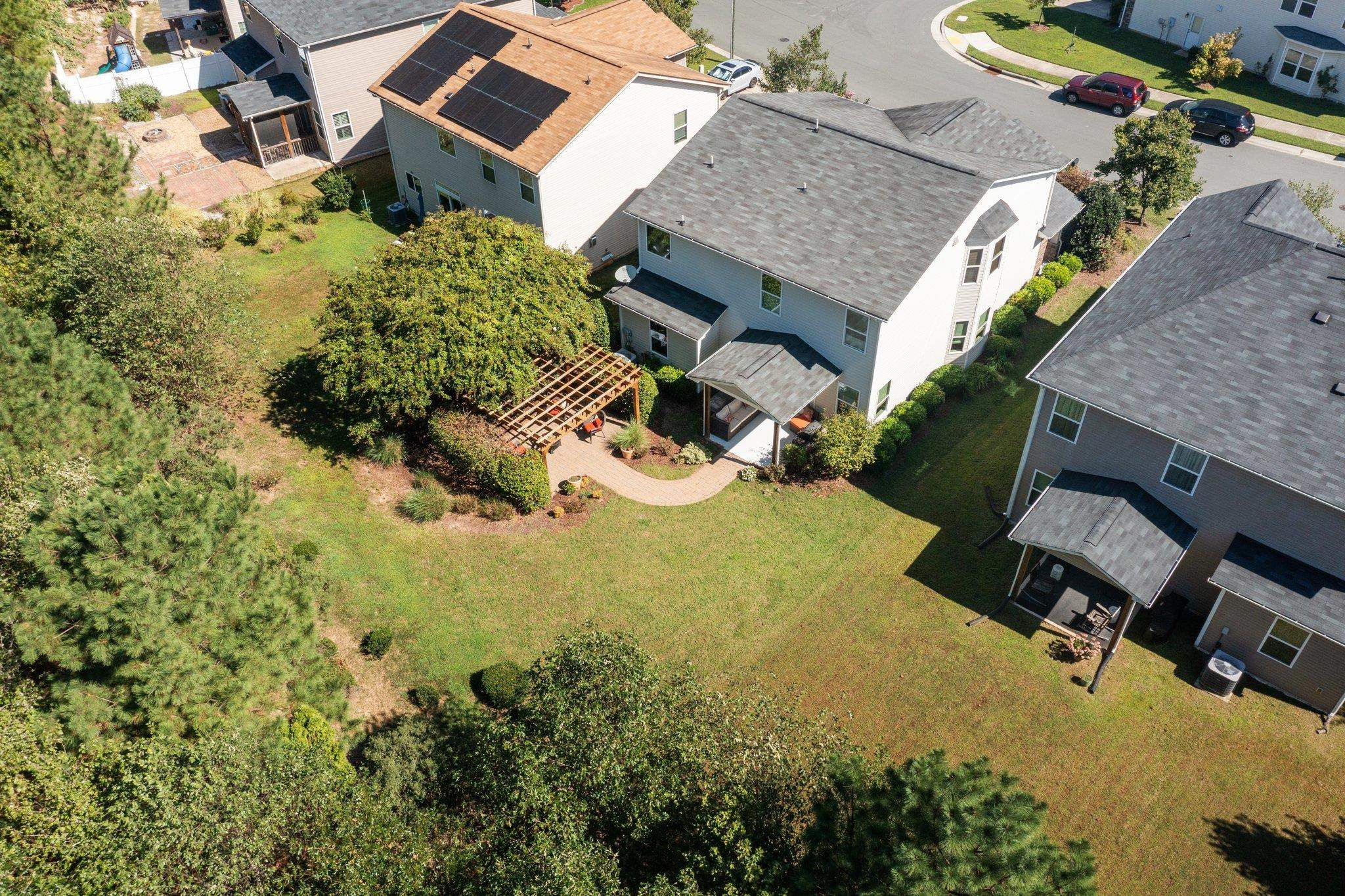 103 Daneborg Road Durham, NC 27703 - Photo 37 of 44 an aerial view of a house with swimming pool and large trees