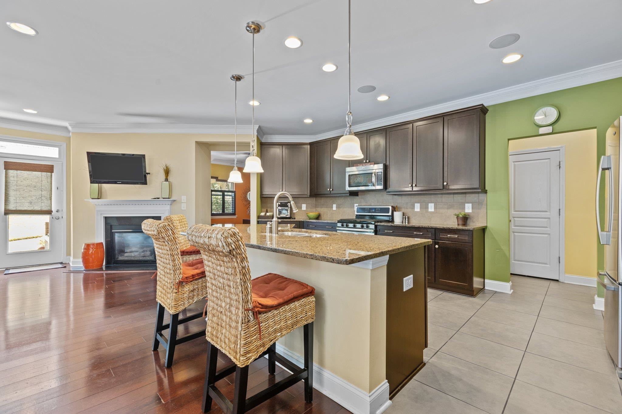103 Daneborg Road Durham, NC 27703 - Photo 8 of 44 a kitchen with stainless steel appliances granite countertop a stove top oven a sink dishwasher a dining table and chairs with wooden floor
