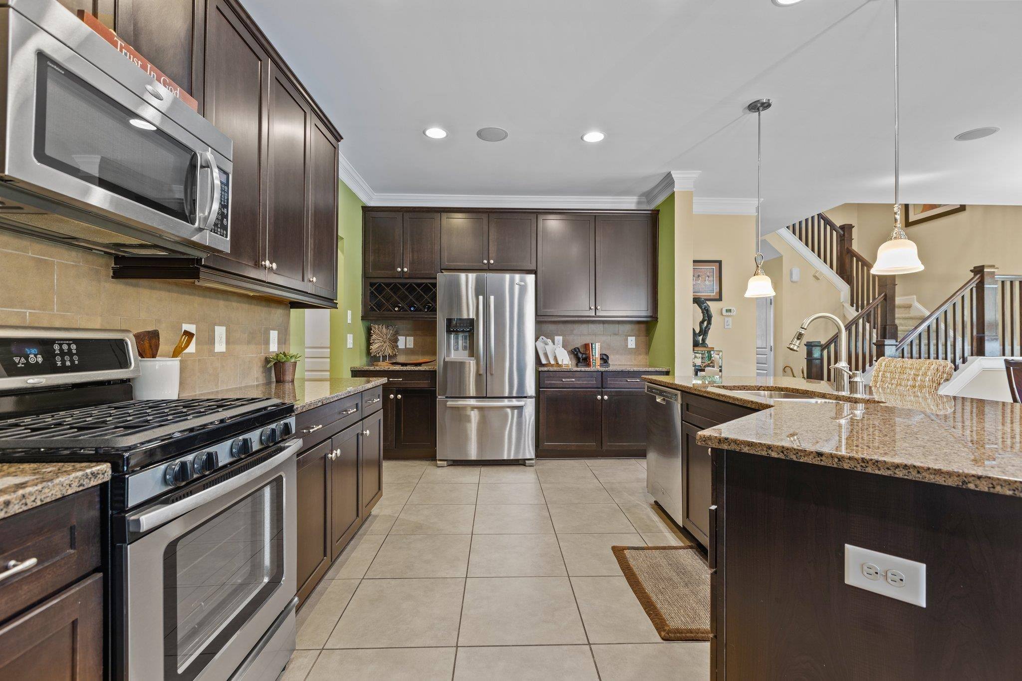 103 Daneborg Road Durham, NC 27703 - Photo 9 of 44 a kitchen with stainless steel appliances granite countertop a sink a stove and a refrigerator