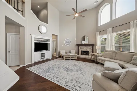 a living room with furniture a window and a fireplace
