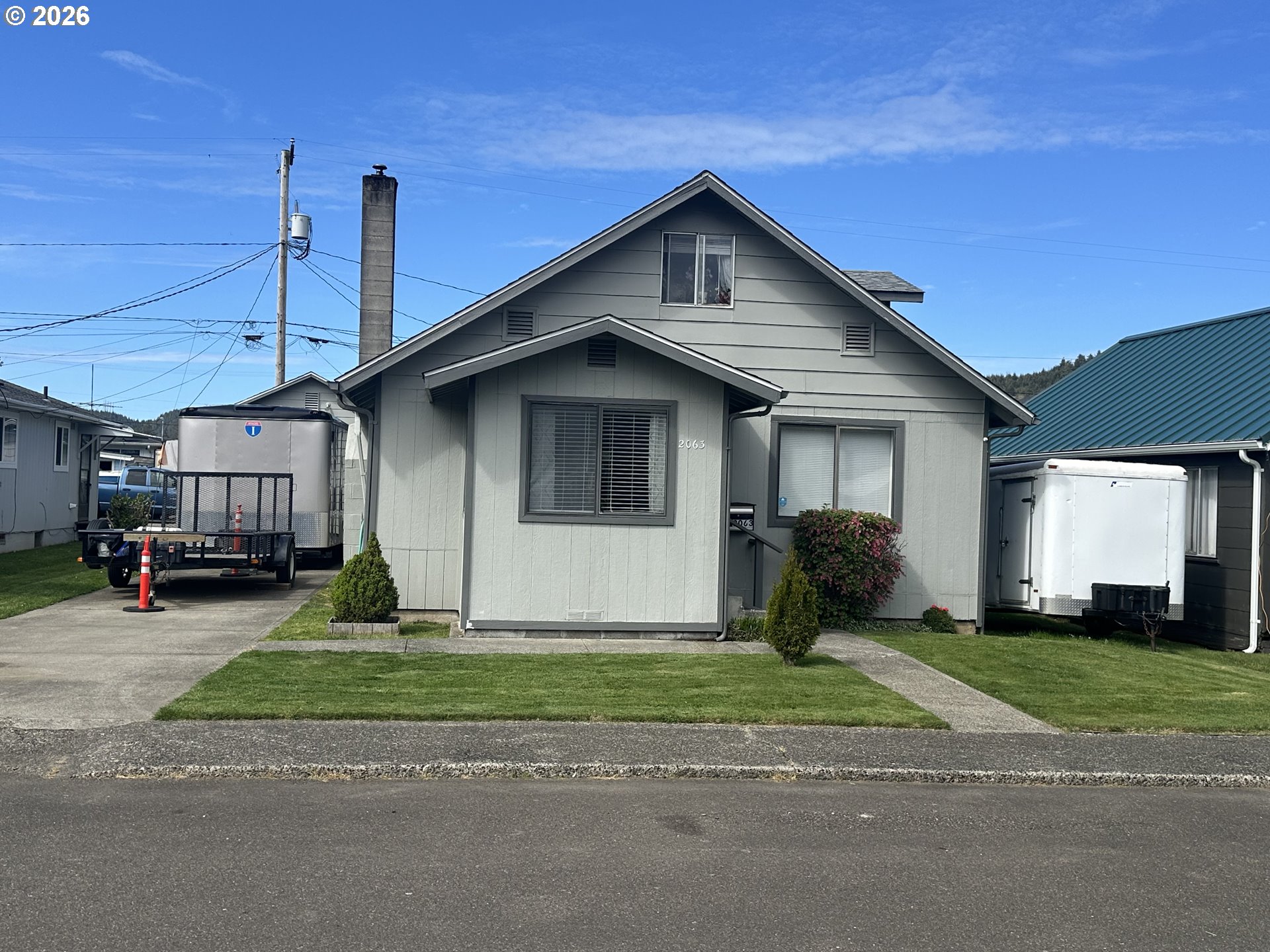 a view of a house with a yard next to a road