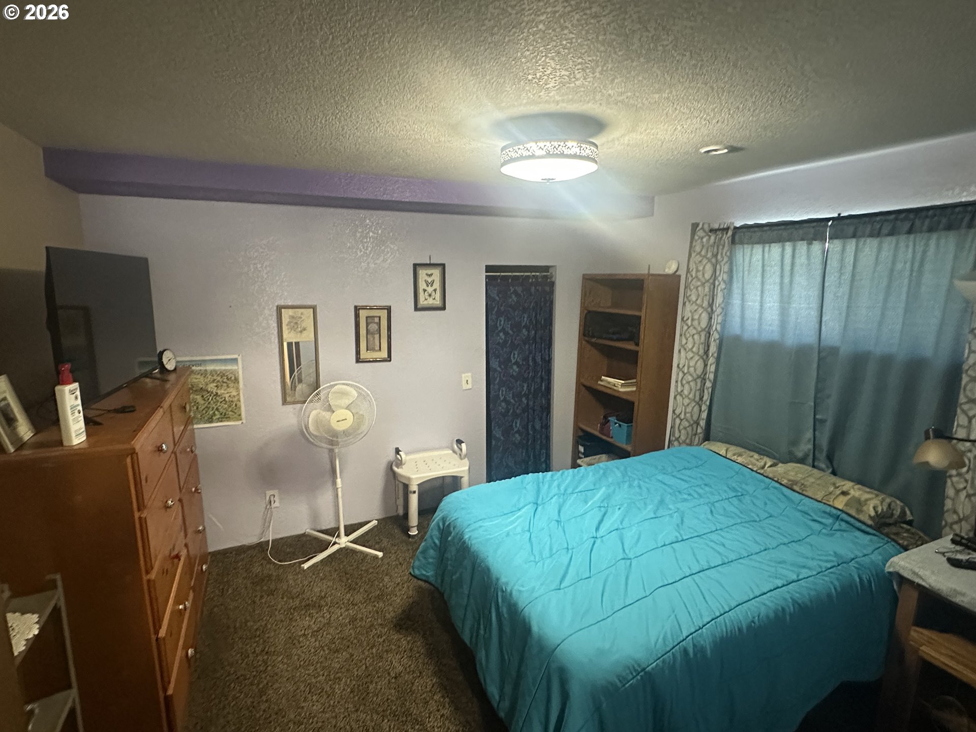 2063 Alder Avenue Reedsport, OR 97467 - Photo 6 of 29 a bedroom with a bed and a flat screen tv