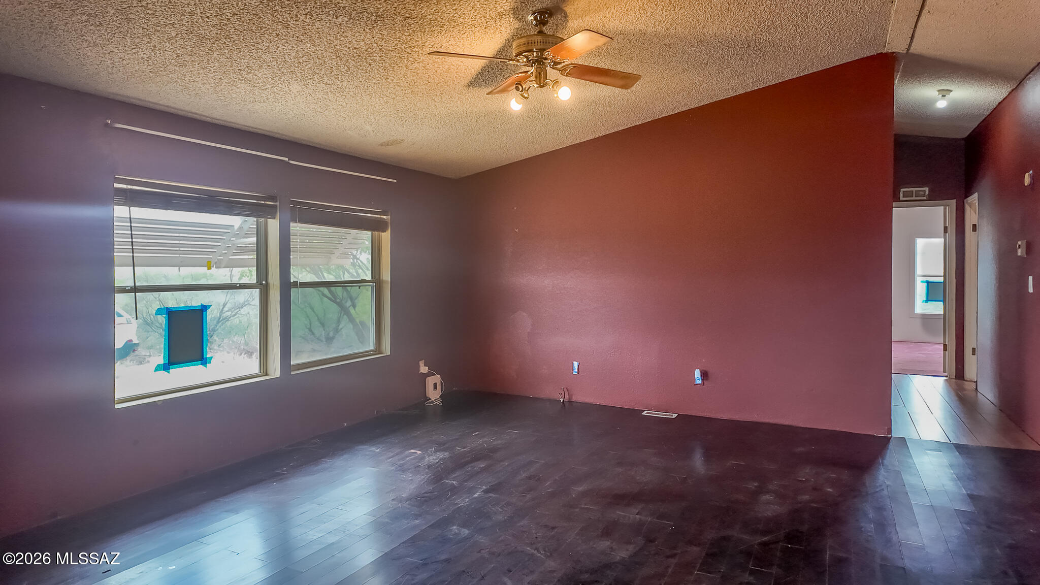 27651 South Canoa Road Amado, AZ 85645 - Photo 5 of 20 a view of an empty room with a window and wooden floor