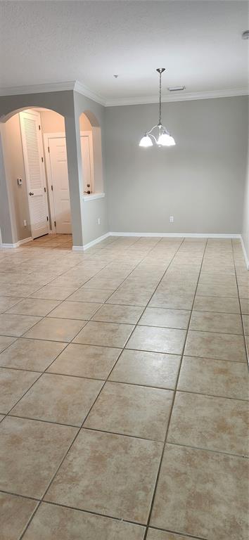 8180 Boat Hook Loop, Unit 310 Windermere, FL 34786 - Photo 4 of 11 an empty room with kitchen and chandelier fan