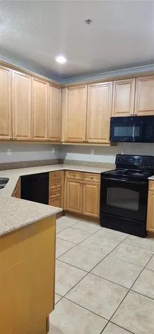 a kitchen with a sink a stove and cabinets