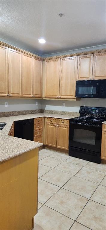 8180 Boat Hook Loop, Unit 310 Windermere, FL 34786 - Photo 7 of 11 a kitchen with stainless steel appliances granite countertop a stove a sink and a microwave