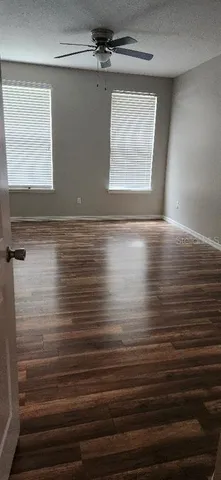 a view of room with window and wooden floor