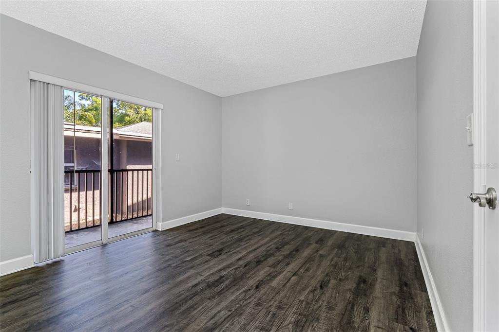 263 14th Street Northwest, Unit 3A Largo, FL 33770 - Photo 8 of 11 a view of wooden floor and windows in a room