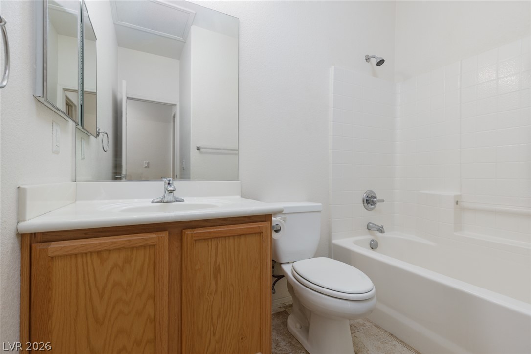 787 Rise Canyon Drive Henderson, NV 89052 - Photo 16 of 22 A well-appointed bathroom with a classic white tub and shower combination awaits.