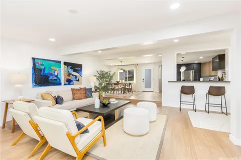 a living room with furniture and kitchen view