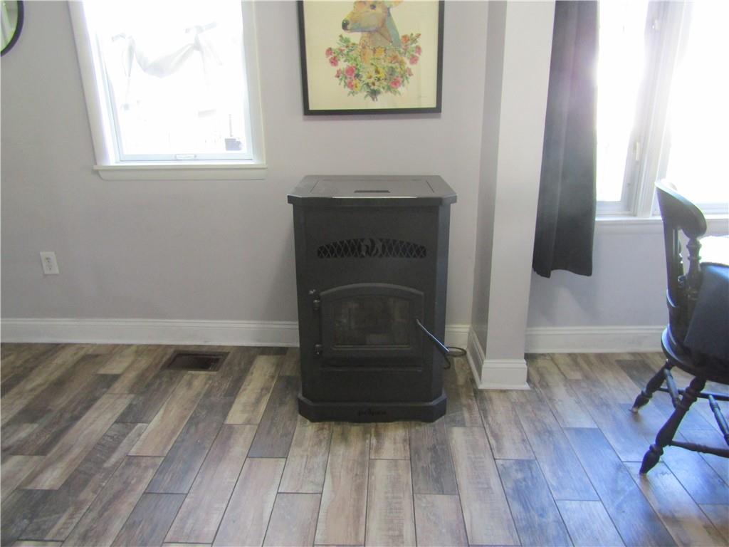 135 Mennonite Camp Road Mount Pleasant, PA 15666 - Photo 19 of 37 pellet stove between kitchen and dining area