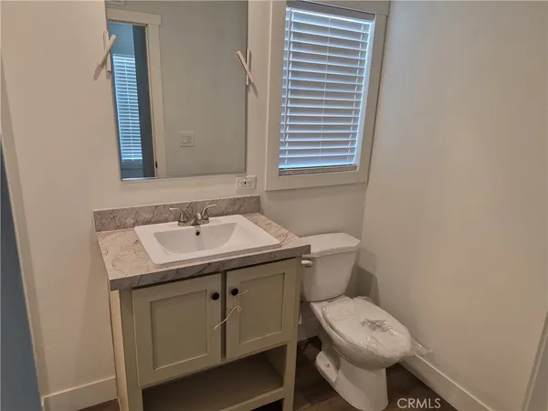 a bathroom with a sink toilet and mirror