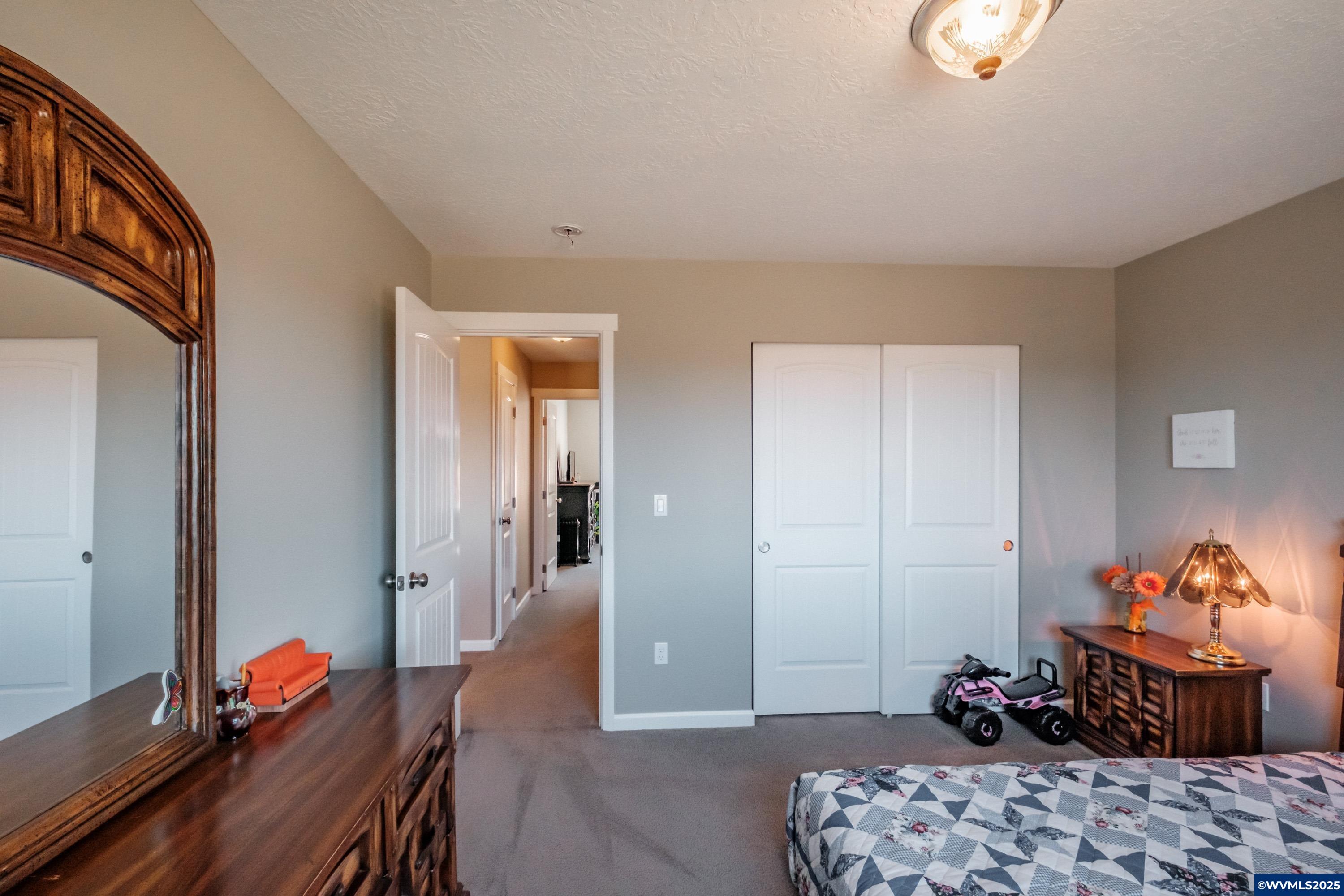 12433 Summit Loop Road Southeast Turner, OR 97392 - Photo 27 of 41 a bedroom with furniture and a bed
