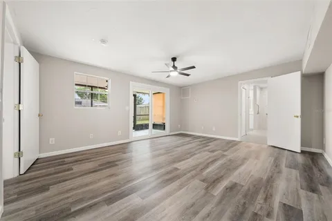 a spacious bedroom with a bed and a flat screen tv