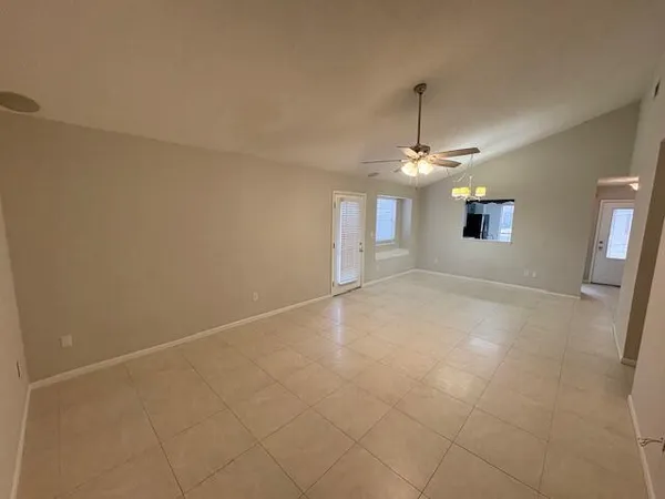 an empty room with windows and entrance