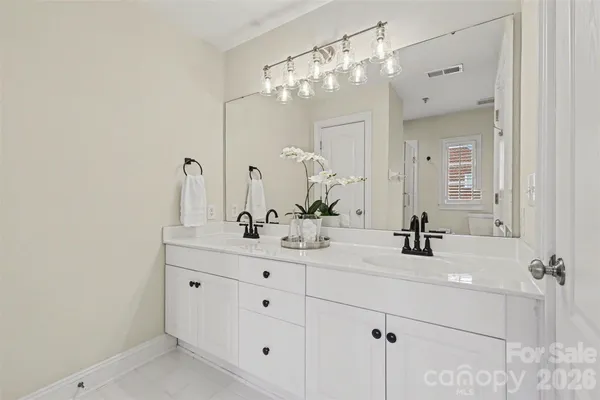 a bathroom with a sink vanity and a mirror