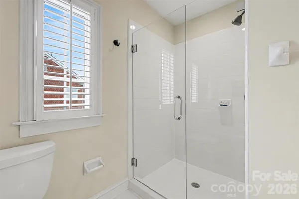 a bathroom with a shower and a window