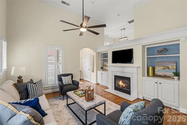 a living room with furniture a flat screen tv and a fireplace
