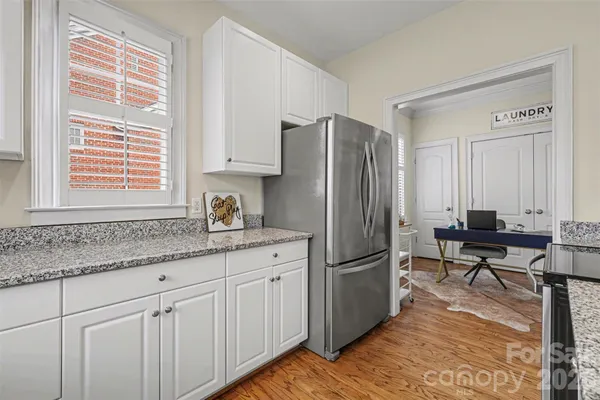 a kitchen with stainless steel appliances granite countertop a refrigerator and a sink