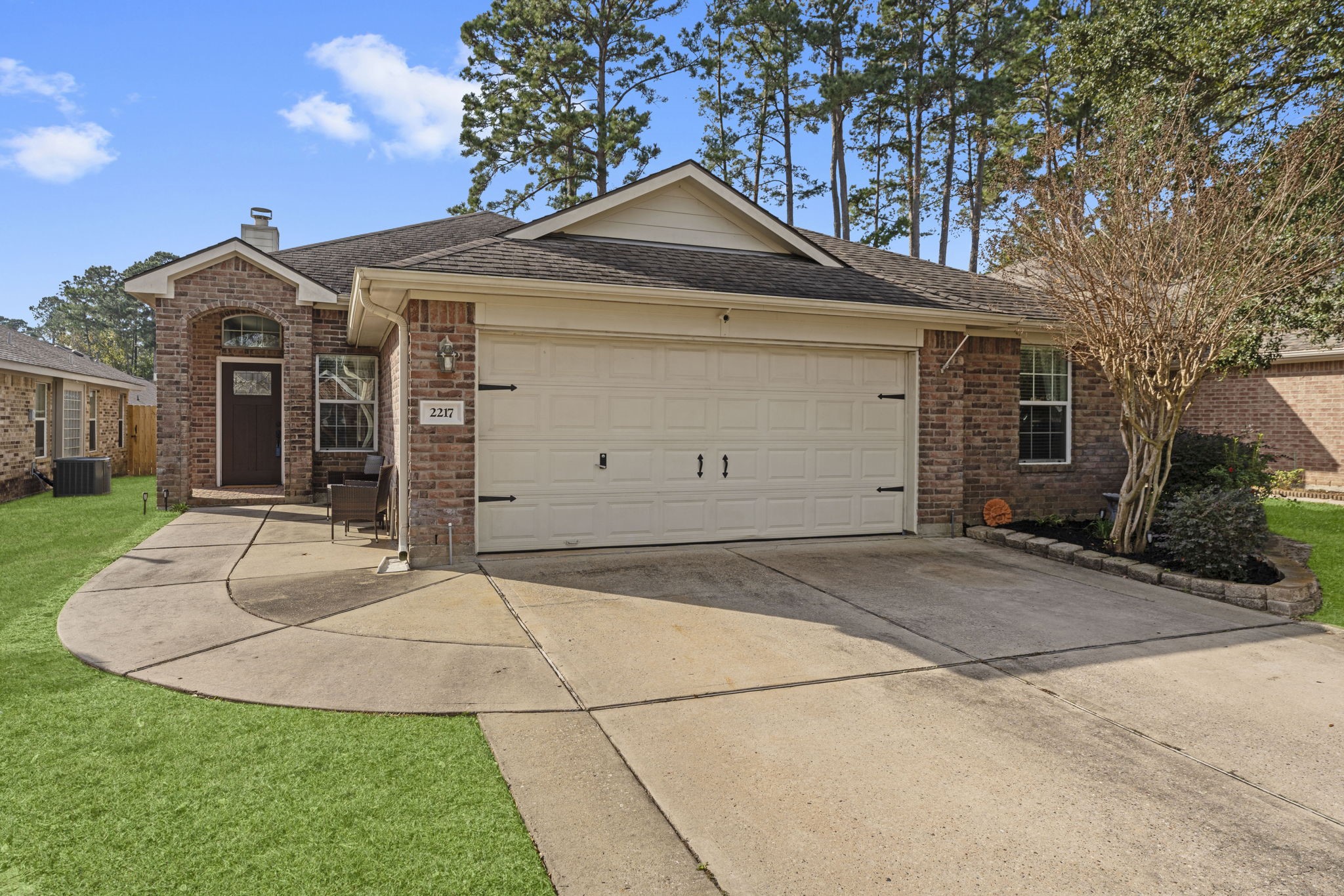 2217 Valley View Crossing Conroe, TX 77304 - Photo 1 of 24 a front view of a house with a yard and garage