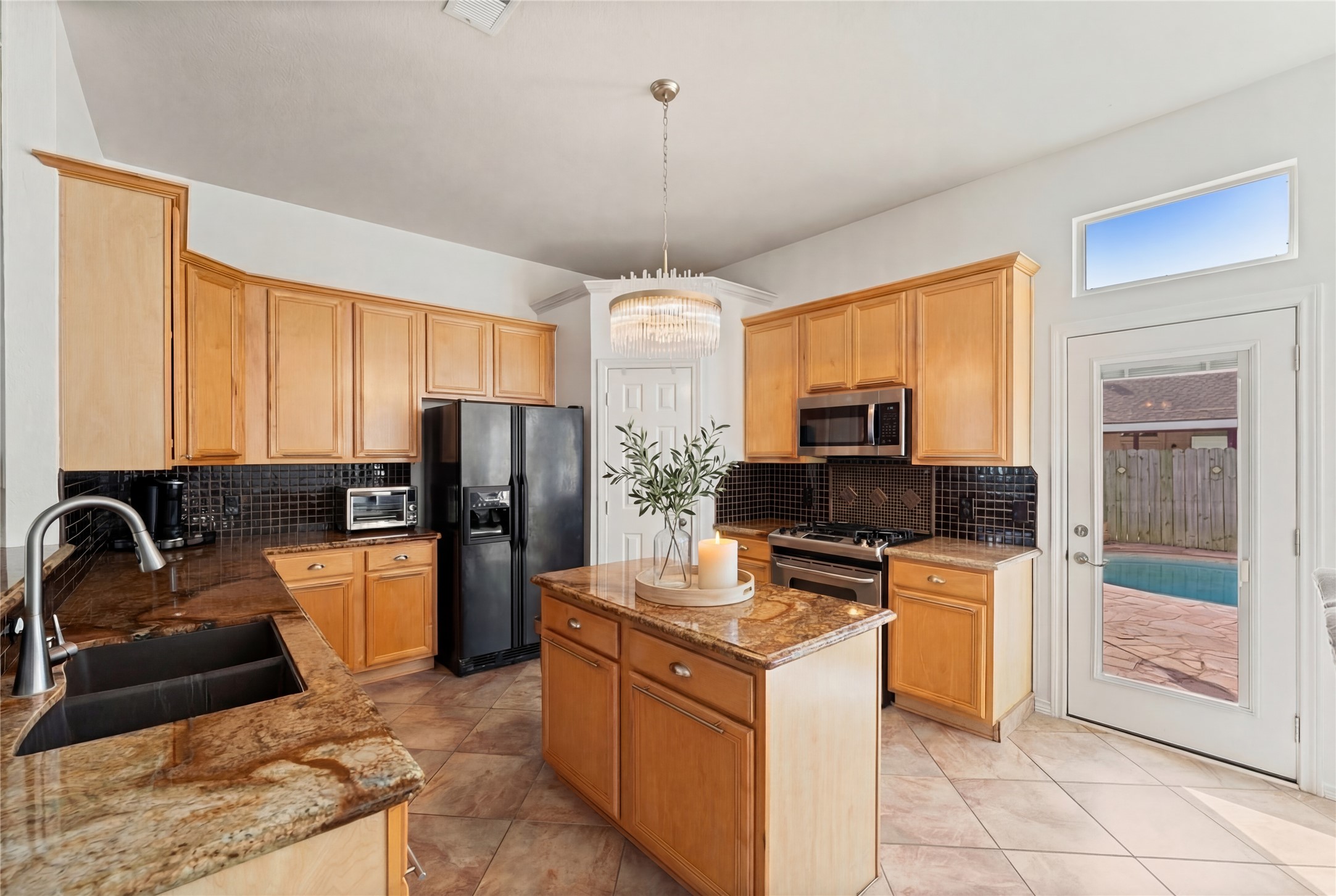 2217 Valley View Crossing Conroe, TX 77304 - Photo 24 of 24 a kitchen with refrigerator cabinets and furniture