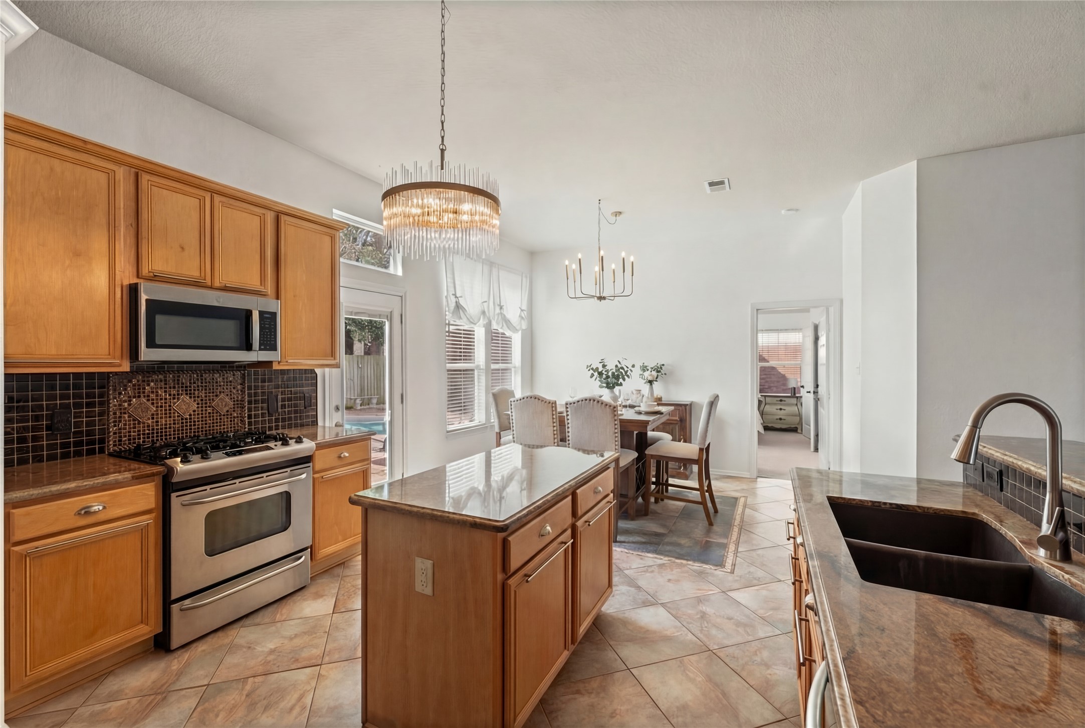 2217 Valley View Crossing Conroe, TX 77304 - Photo 10 of 24 a kitchen with a sink stove and microwave