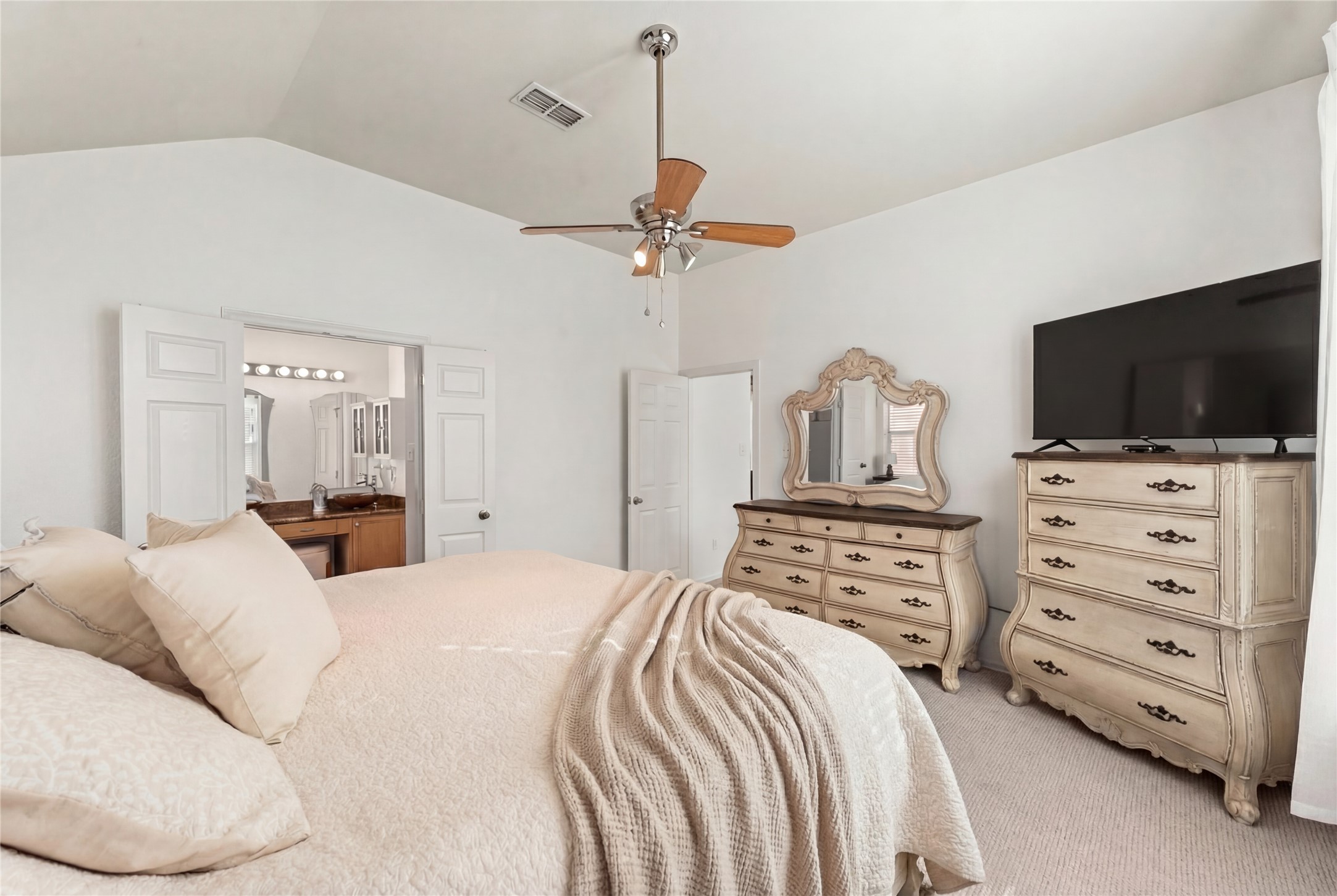 2217 Valley View Crossing Conroe, TX 77304 - Photo 11 of 24 a bedroom with a bed a dresser and flat screen tv
