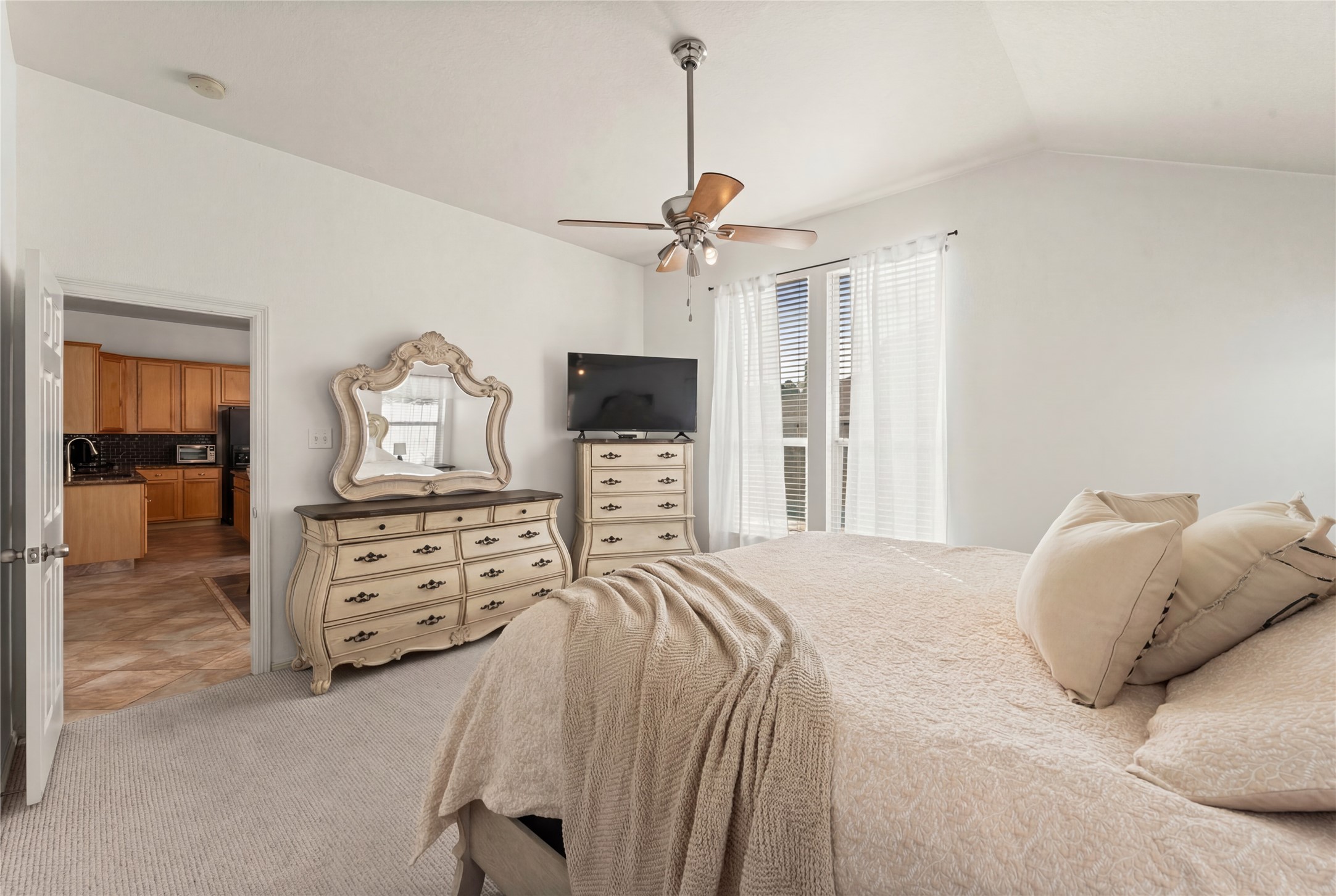 2217 Valley View Crossing Conroe, TX 77304 - Photo 12 of 24 a bedroom with a balcony a bed and dresser with mirror