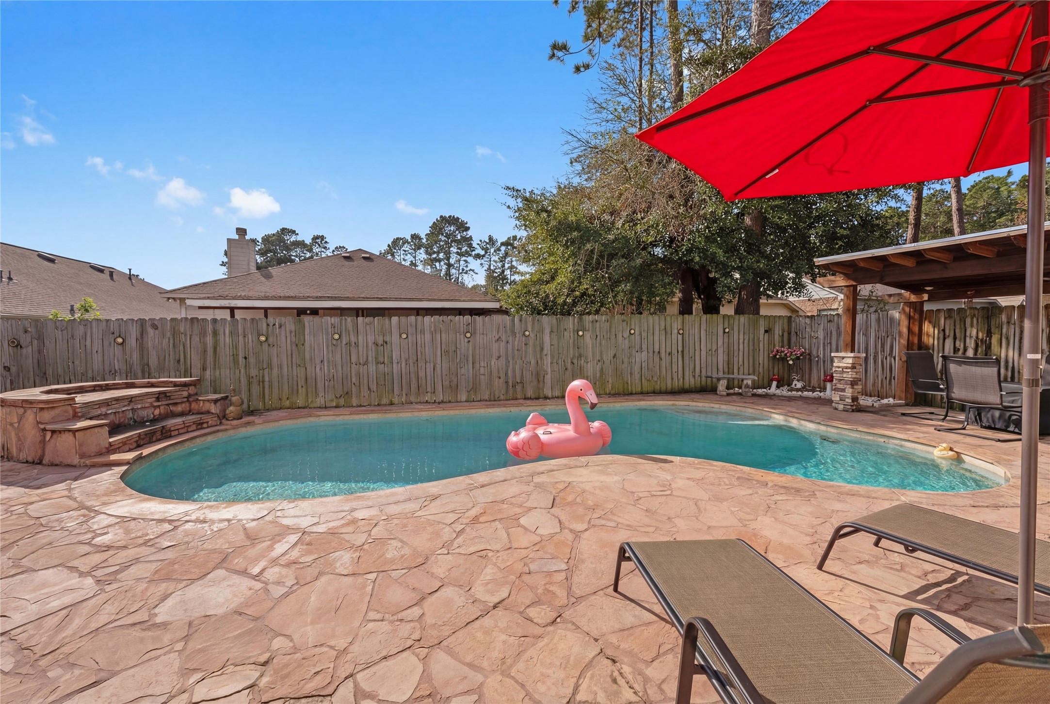 2217 Valley View Crossing Conroe, TX 77304 - Photo 19 of 24 a view of a backyard with sitting area and furniture