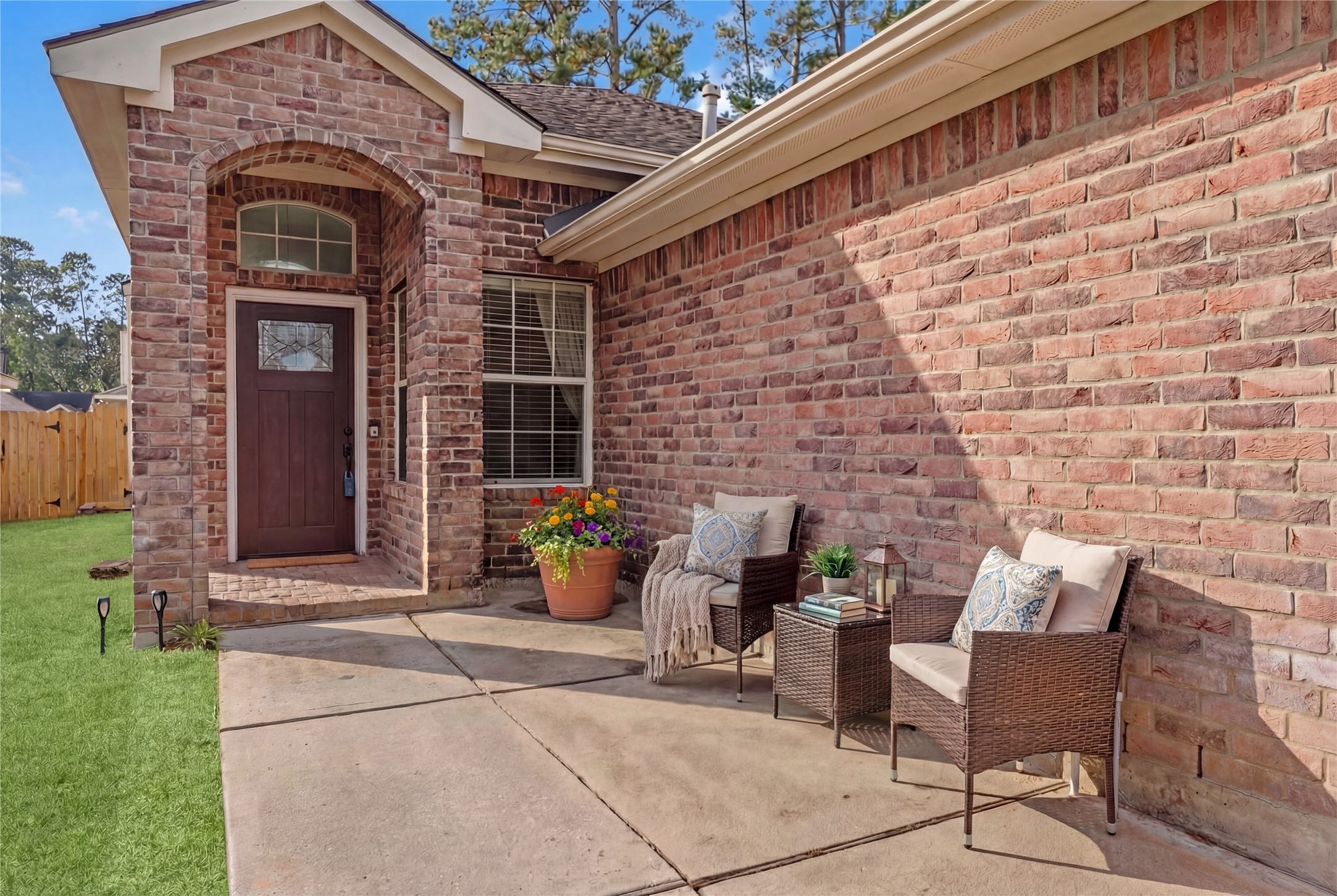 2217 Valley View Crossing Conroe, TX 77304 - Photo 22 of 24 a view of a brick house with outdoor seating space