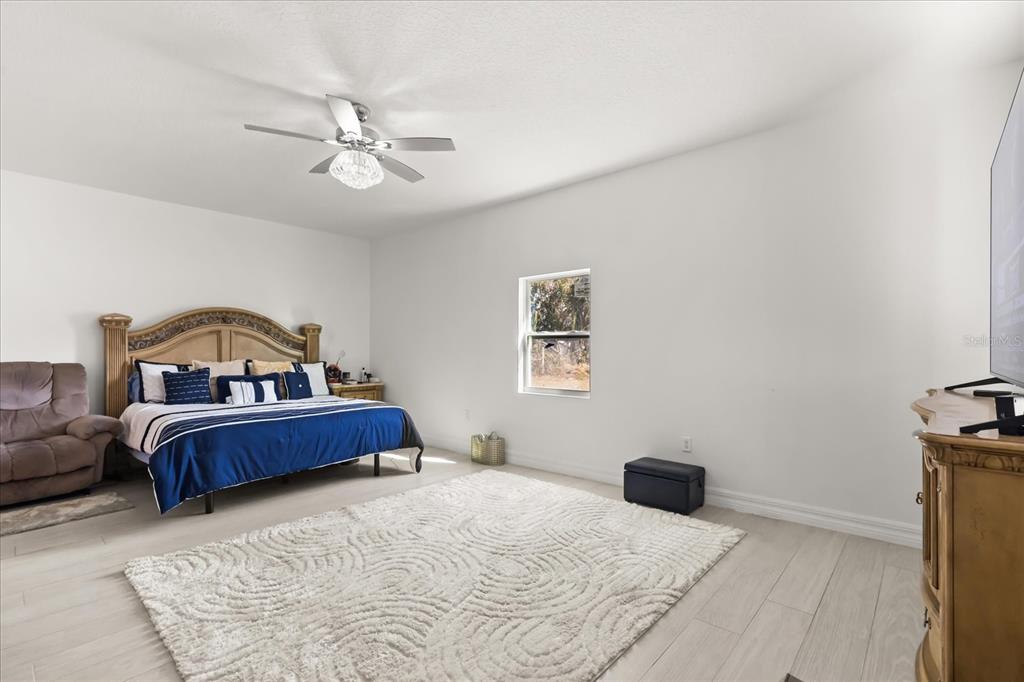 812 Chastain Road Seffner, FL 33584 - Photo 11 of 26 a bedroom with a bed and a chandelier