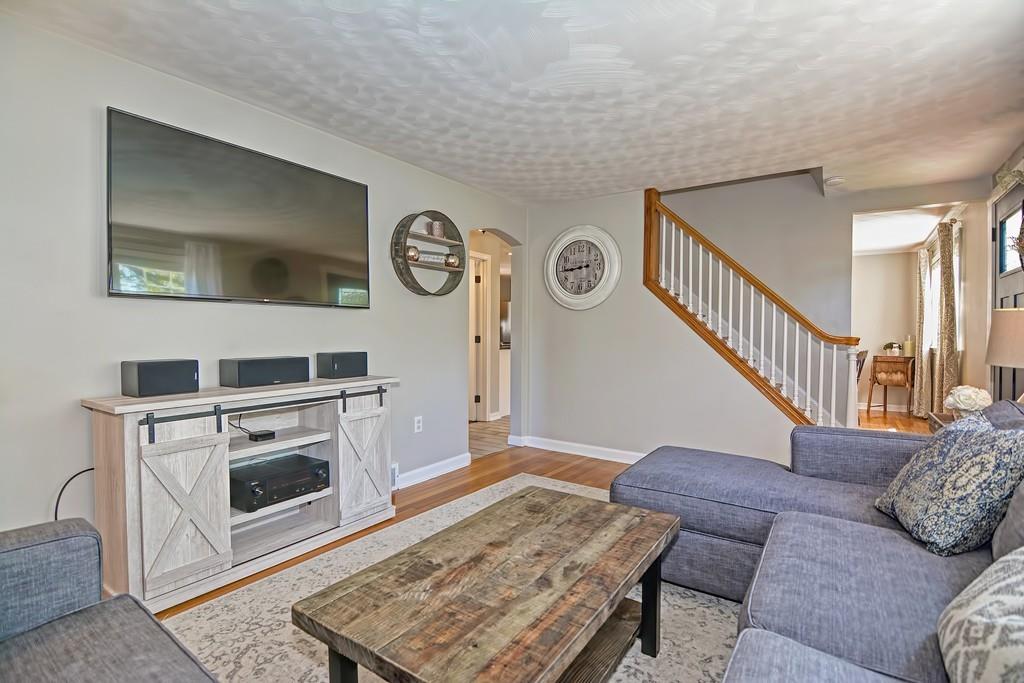 8 Edith Road Hudson, MA 01749 - Photo 11 of 26 a living room with furniture and a fireplace