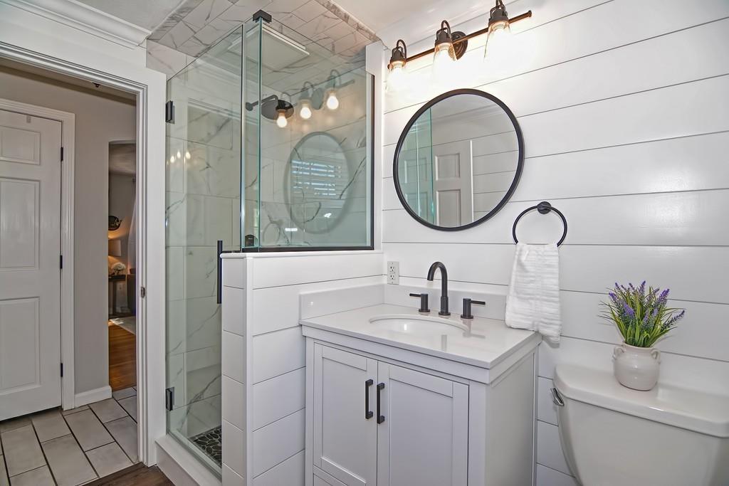 8 Edith Road Hudson, MA 01749 - Photo 15 of 26 a bathroom with a sink a mirror a vanity and a shower