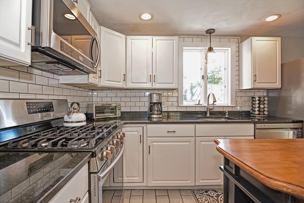 8 Edith Road Hudson, MA 01749 - Photo 6 of 26 a kitchen with granite countertop a sink stove and cabinets
