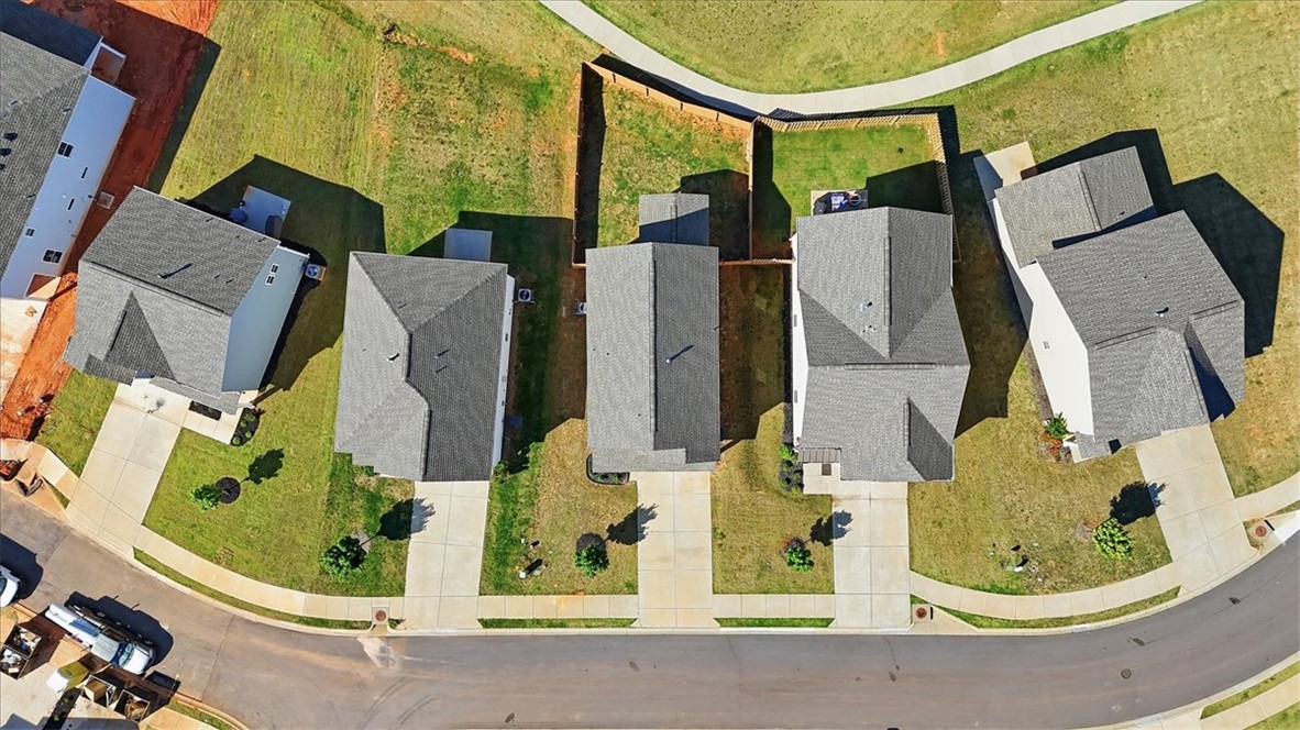 403 Seaborn Circle Pendleton, SC 29670 - Photo 37 of 47 An aerial perspective reveals a residential street with well-maintained homes featuring gray roofs and neatly kept lawns.