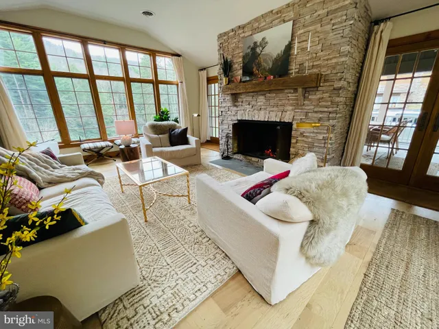 a bedroom with a bed and large windows