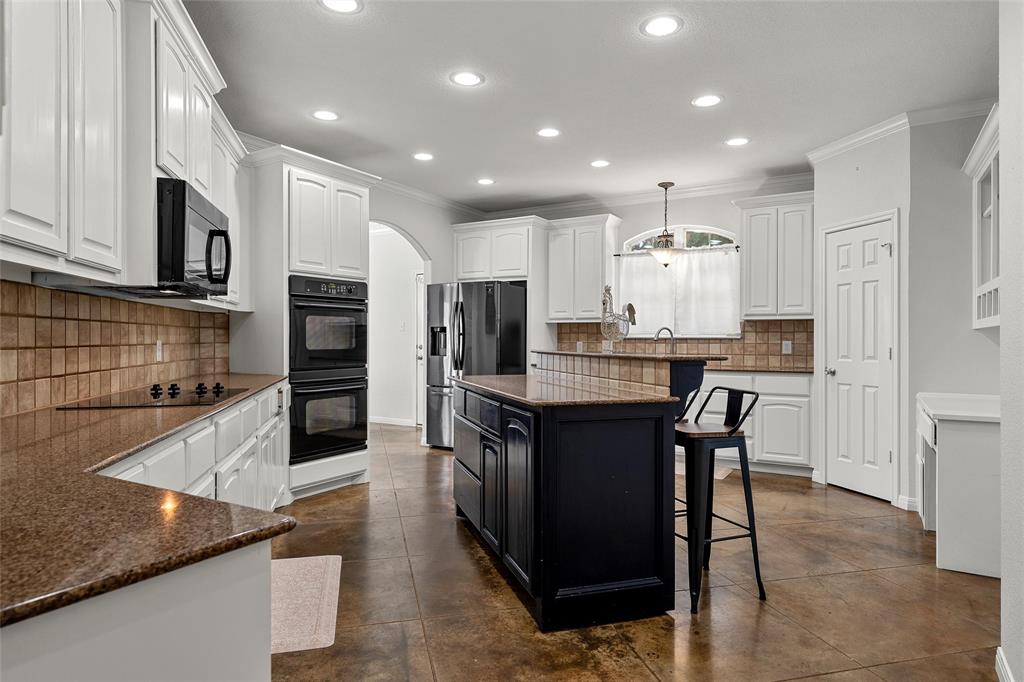3696 Old Lorena Road Lorena, TX 76655 - Photo 12 of 27 Spacious kitchen featuring white cabinetry, brown granite-finish countertops, and a tiled backsplash